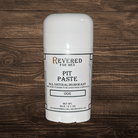White deodorant stick with 'Revered for Men' branding on a wooden surface