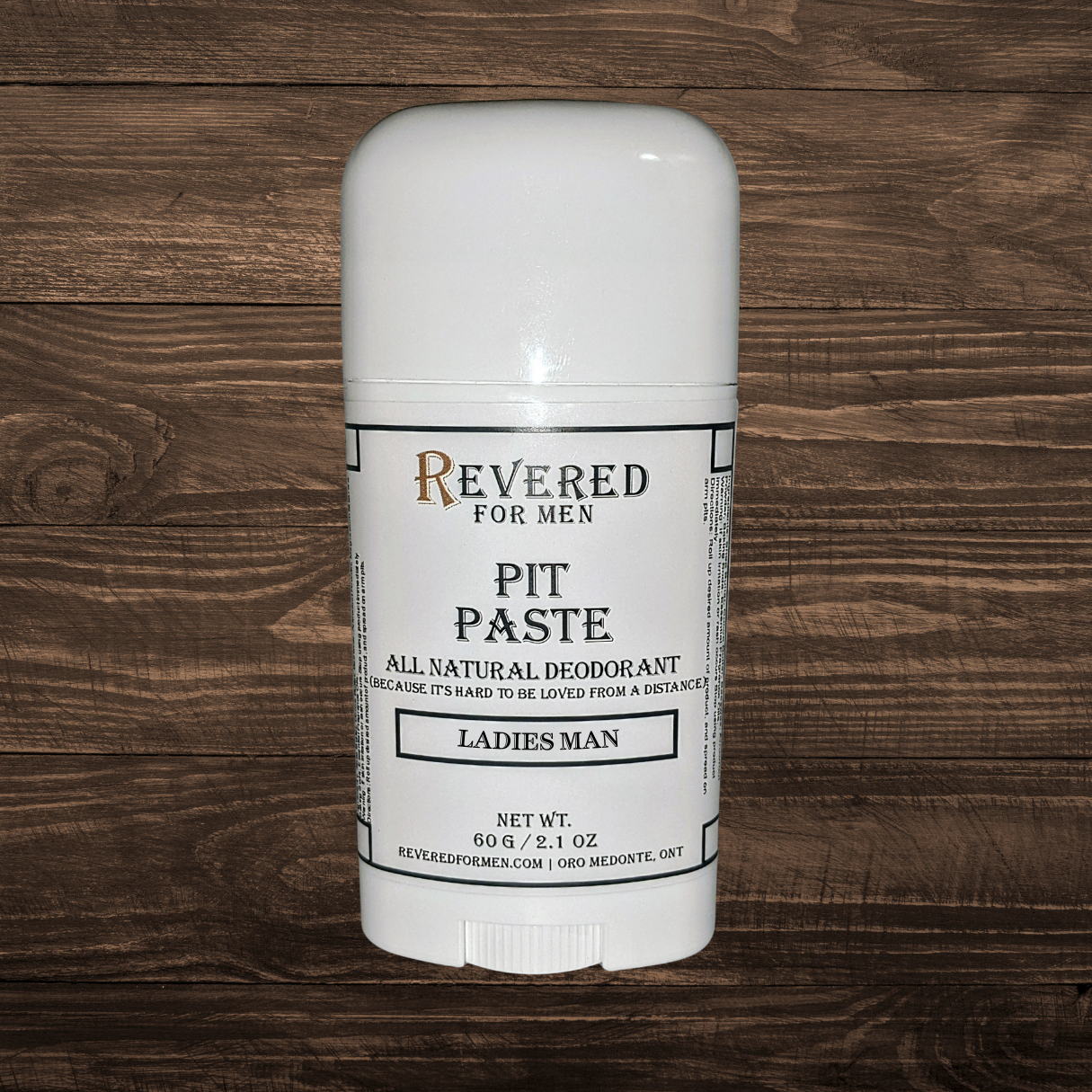 Deodorant stick labeled 'Revered for Men' on a wooden surface