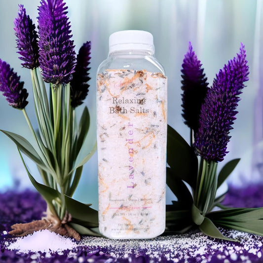 Bottle of Lavender Relaxing Bath Salts surrounded by lavender flowers on a blurred background