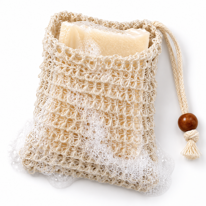 Sisal soap saver bag holding an ivory soap bar, with lather and a drawstring bead. Soap sold separately.